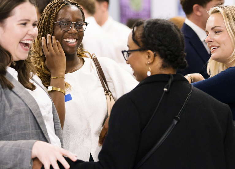 UCD Alumni engage in a conversation in an event.
